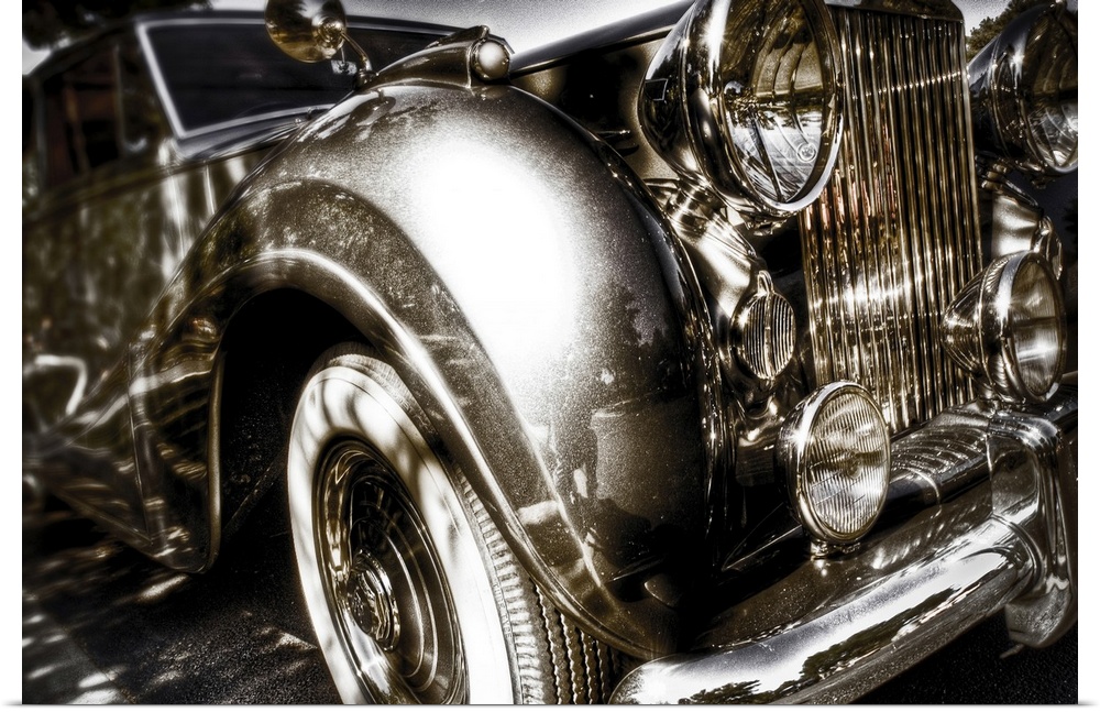 A vintage Rolls Royce motorcar with gleaming chrome grill and bumper