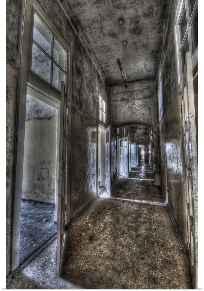 Abandoned lunatic asylum north of Berlin, Germany. Empty corridor with open doors.