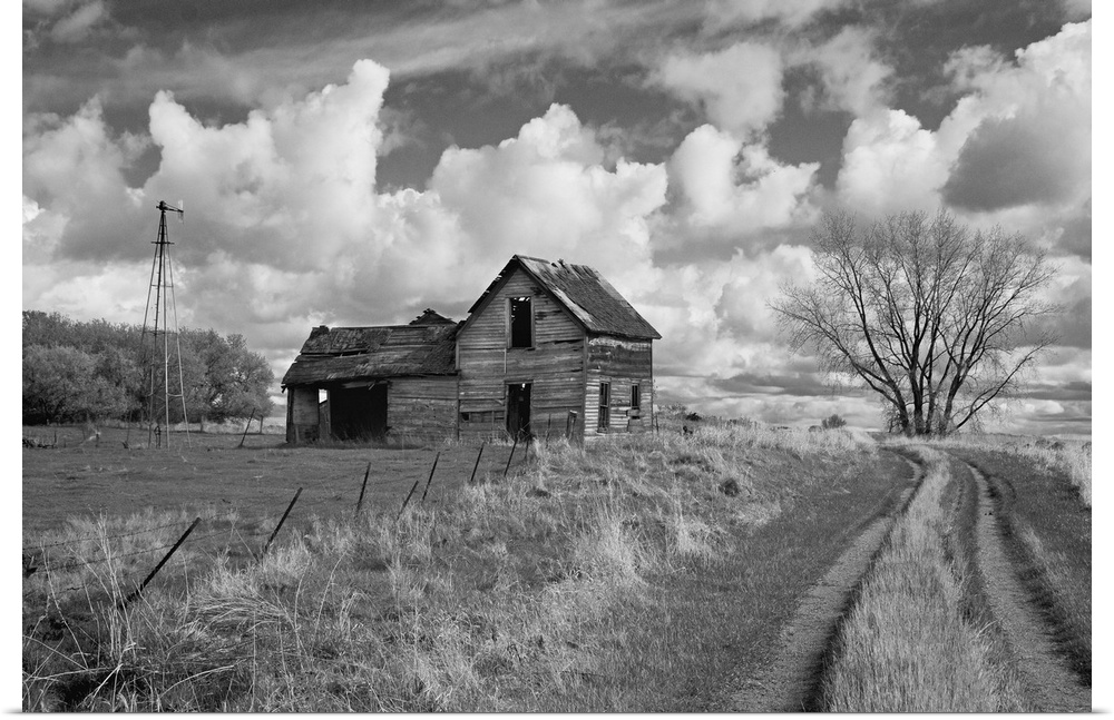 rural scene with old barn and farm track under cloudy sky in Rolette County USA