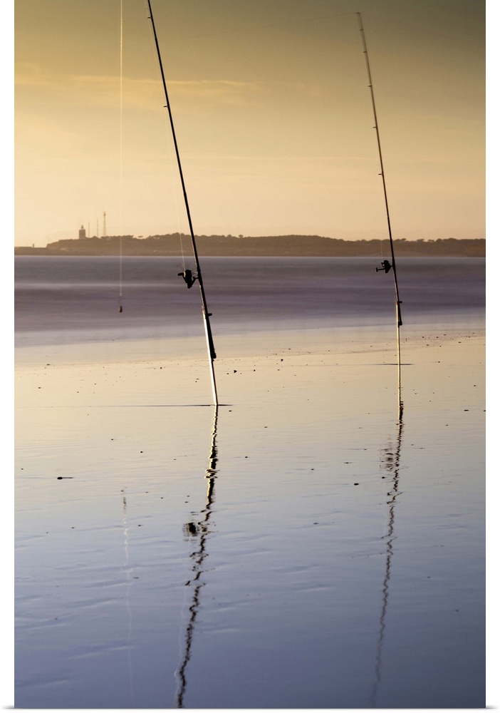 Two fishing rods on the beach. Long exposure shot.