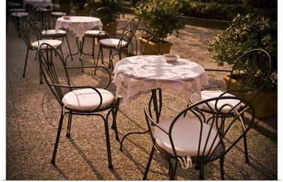 Tables are set at an outdoor bistro in Italy
