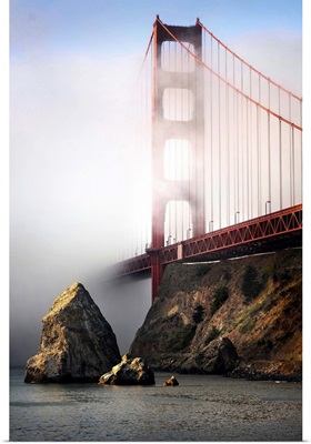 The Golden Gate bridge shrouded in mist at sunrise
