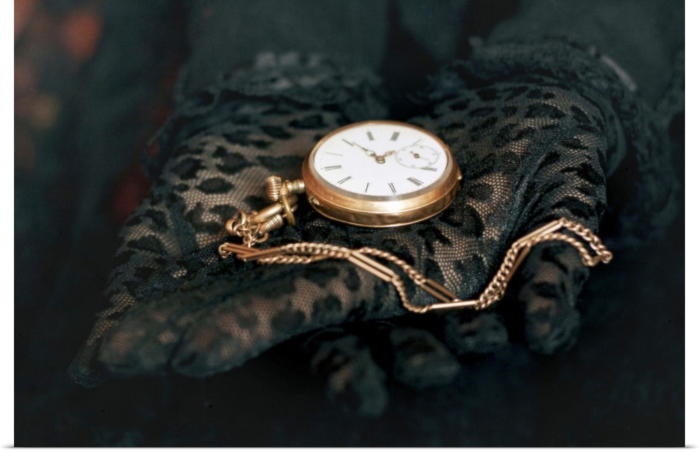 Two hands in black lace gloves holding necklace with open golden pocket watch