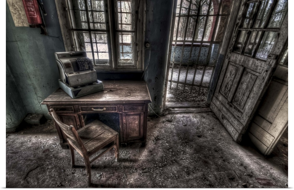 Abandoned lunatic asylum north of Berlin, Germany. Cash till on desk with chair.