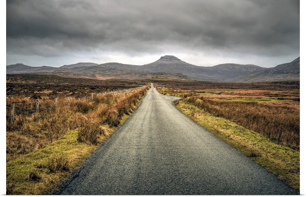 Long straight road towards distant hills in Scotland, UK.