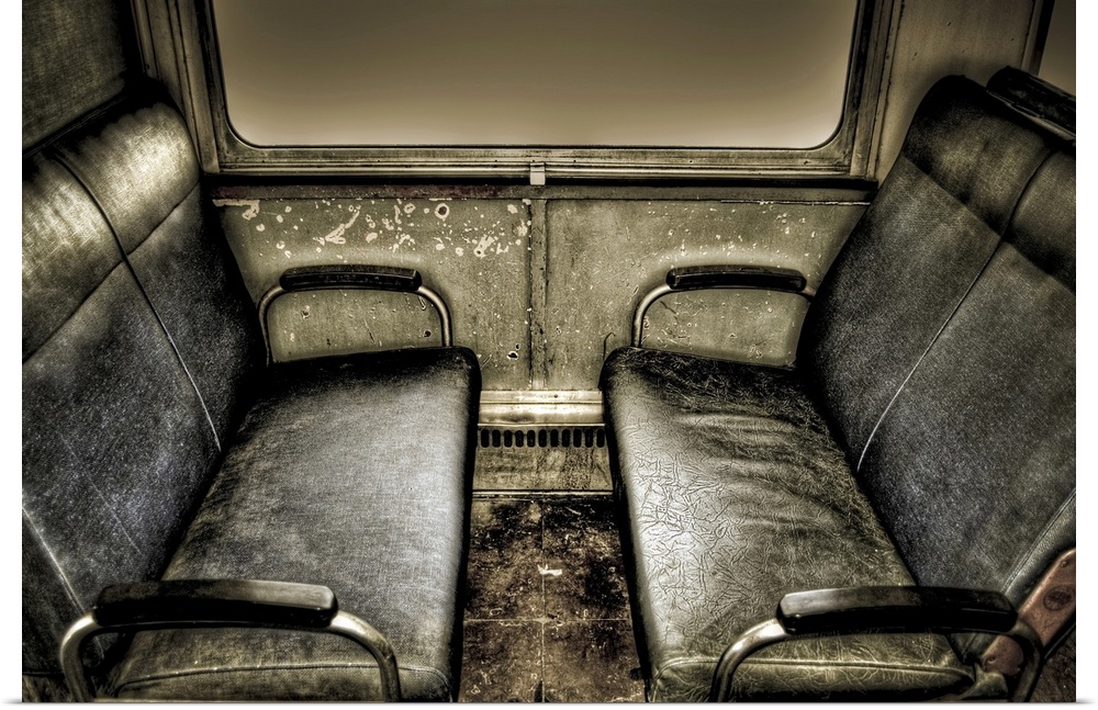 Interior of old train carriage with black seats