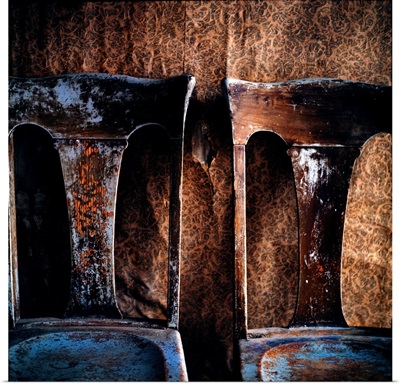Two old chairs against a wall