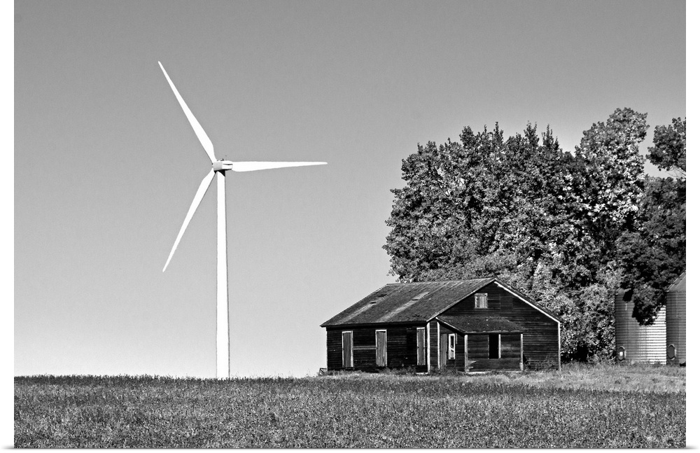 Wind turbine in rural location with old barn in Cavalier County USA
