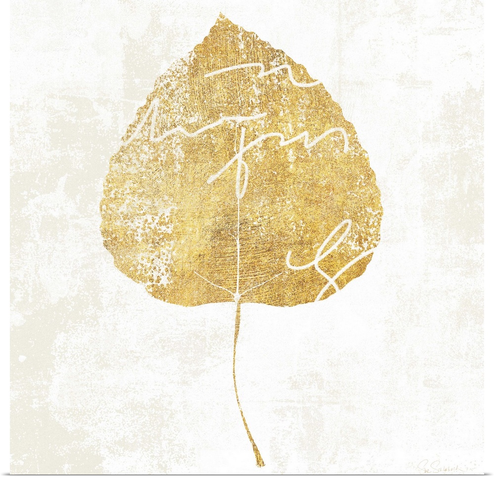 Gold silhouette of a leaf with white writing.