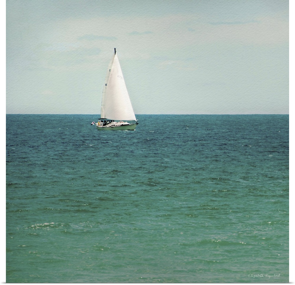 A photograph of a sailboat out on a green sea.