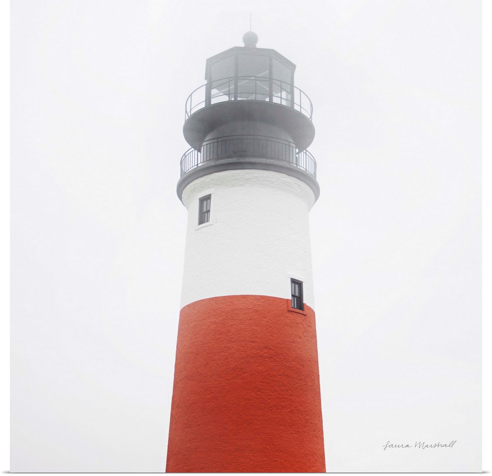 A square photograph of the Sankaty Head Lighthouse in Nantucket Island, Massachusetts, blanketed in a light fog.
