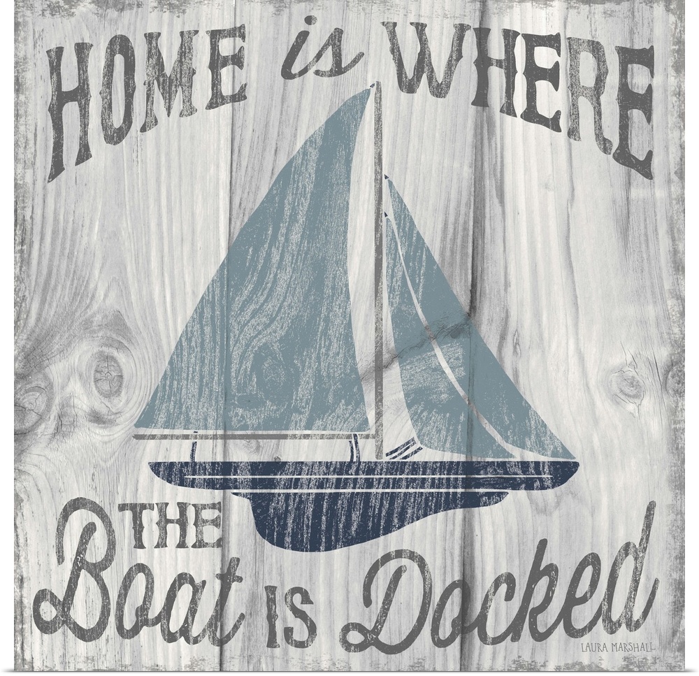 "Home is Where the Boat is Docked" in grey with an illustration of a sailboat in shades of blue on a white and grey wood g...