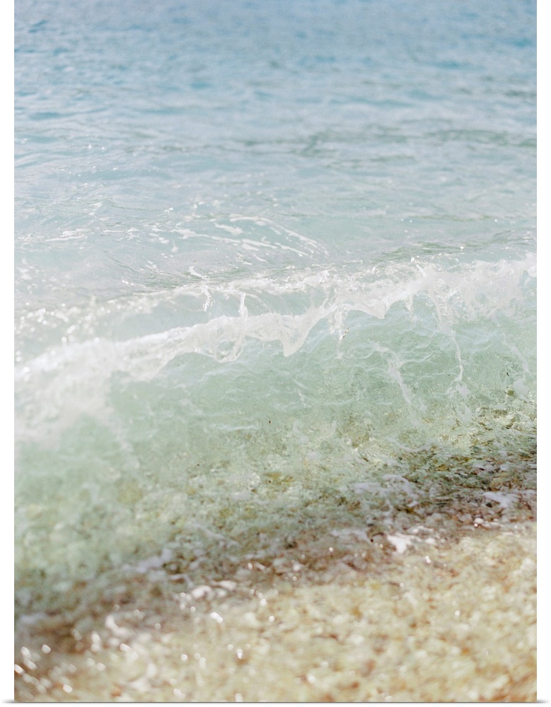 Photograph of clear ocean water lapping the sand, Corfu, Greece.