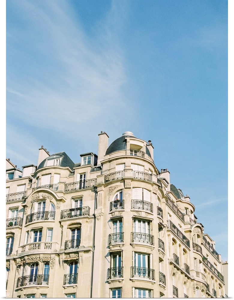 Photograph of Paris apartments buildings beneath a blue sky.