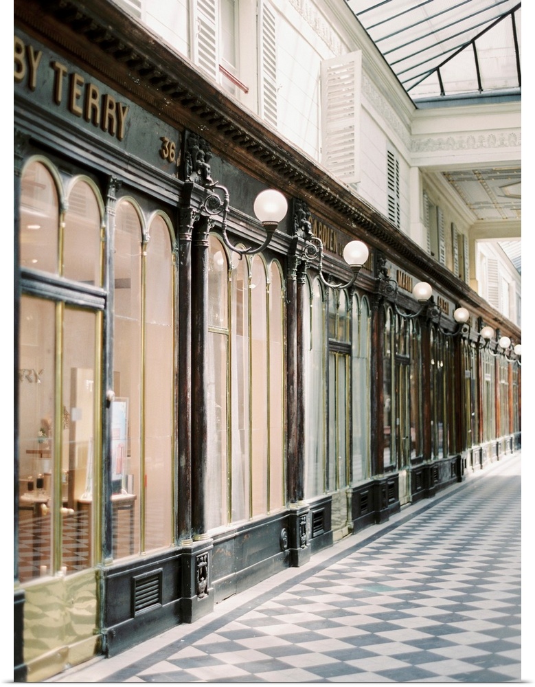 A photograph of an arcade of stores in an elegant shopping district of Paris, France.