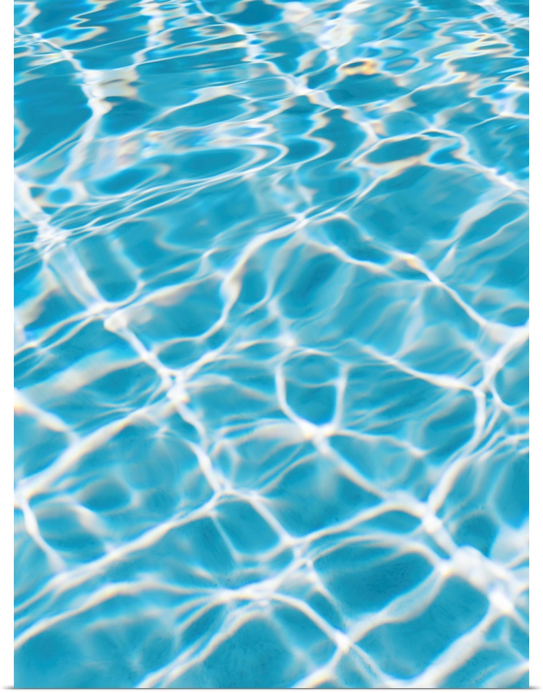 An abstracted photograph of sunlight reflecting off of clear pool water.