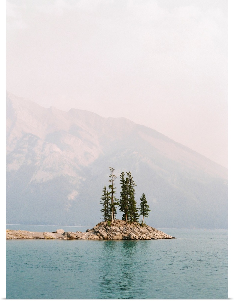 Photograph of several trees on a small island under a hazy sky, Banff, Canada.