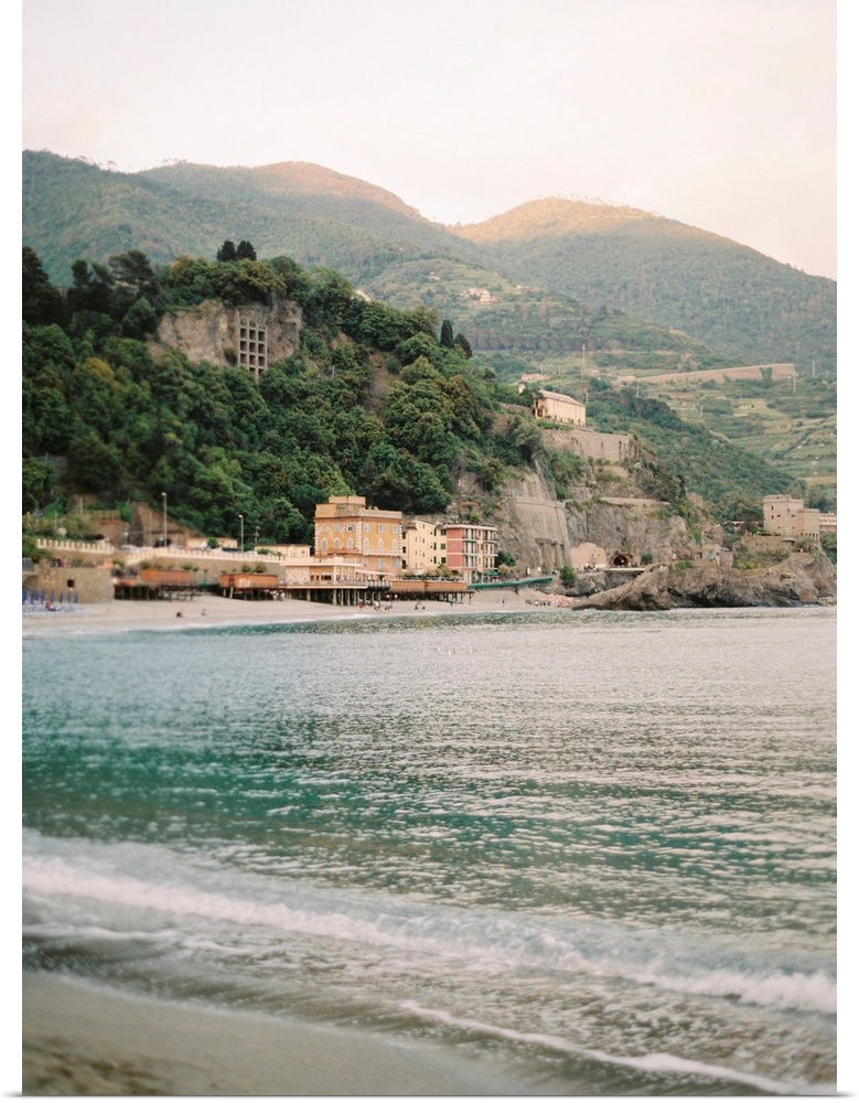 Photograph of the water in front of a sunlit town, Cinque Terre, Italy.