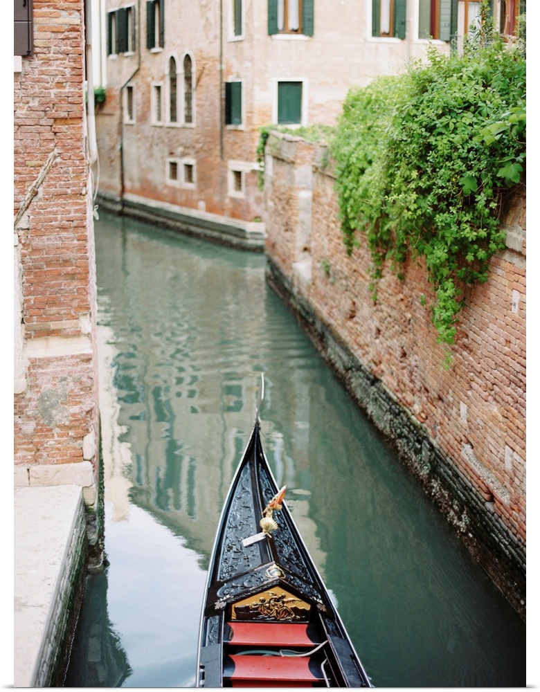 Photograph of the front of a gondola on the water, Venice, Italy.