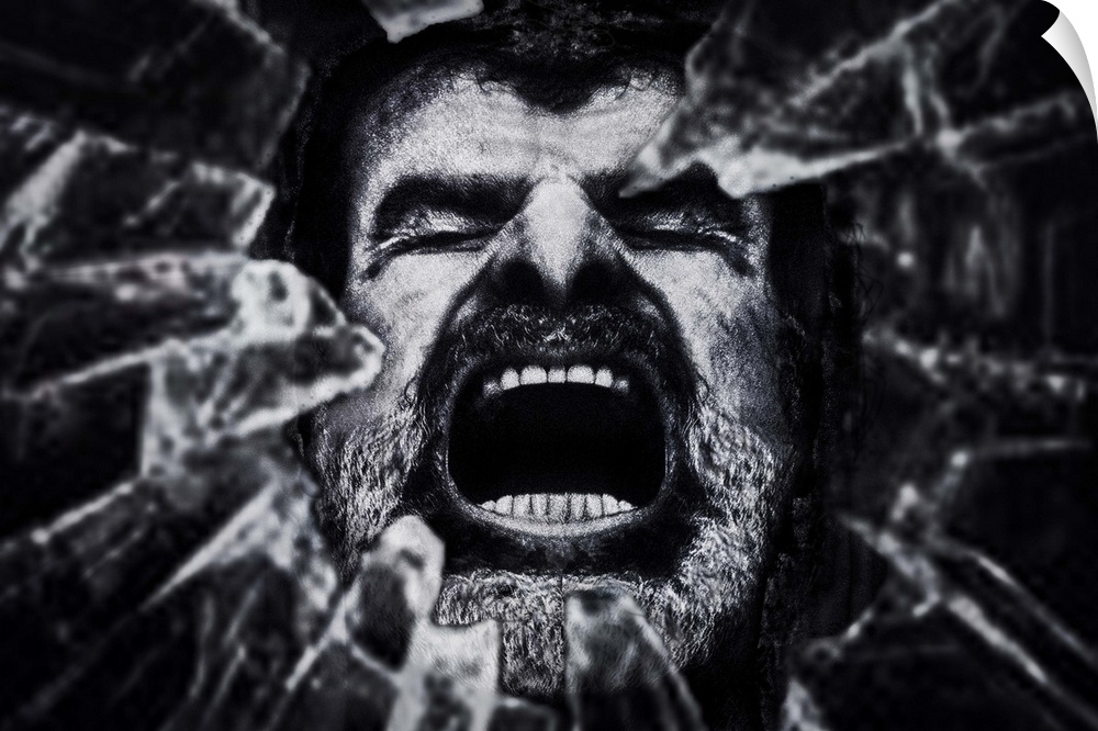 Conceptual photograph of a man face seen through a hole of shattered glass.