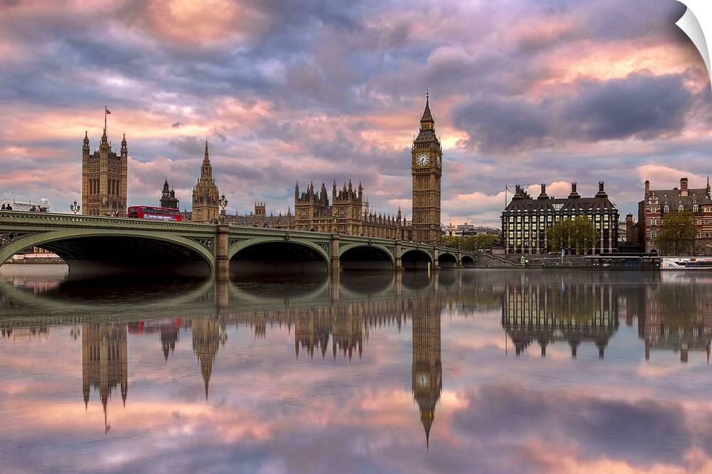 Sunset photograph of the Westminster Bridge with Big Ben and the House of Parliament in the background reflecting on to th...