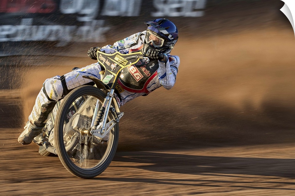 A motocross racer learning into a curve at the Fjelsted Speedway, Denmark.