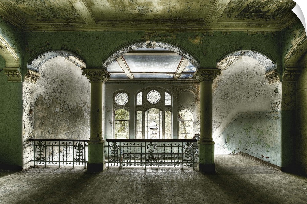 Interior photograph of an abandoned building that has beautiful arches which welcome the daylight coming in through the an...