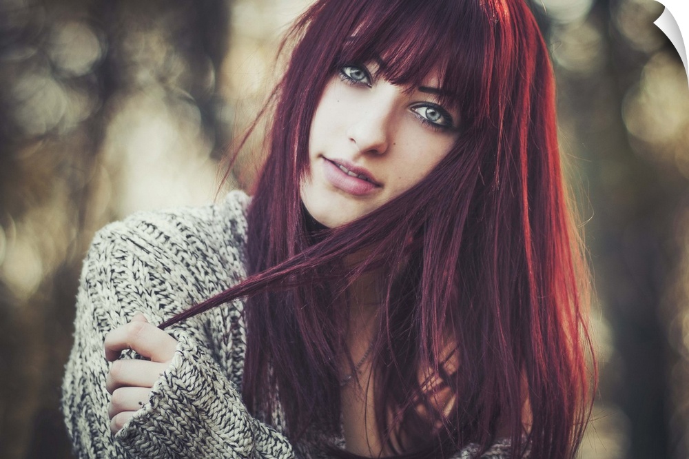 Portrait of a beautiful young woman with dark red hair.