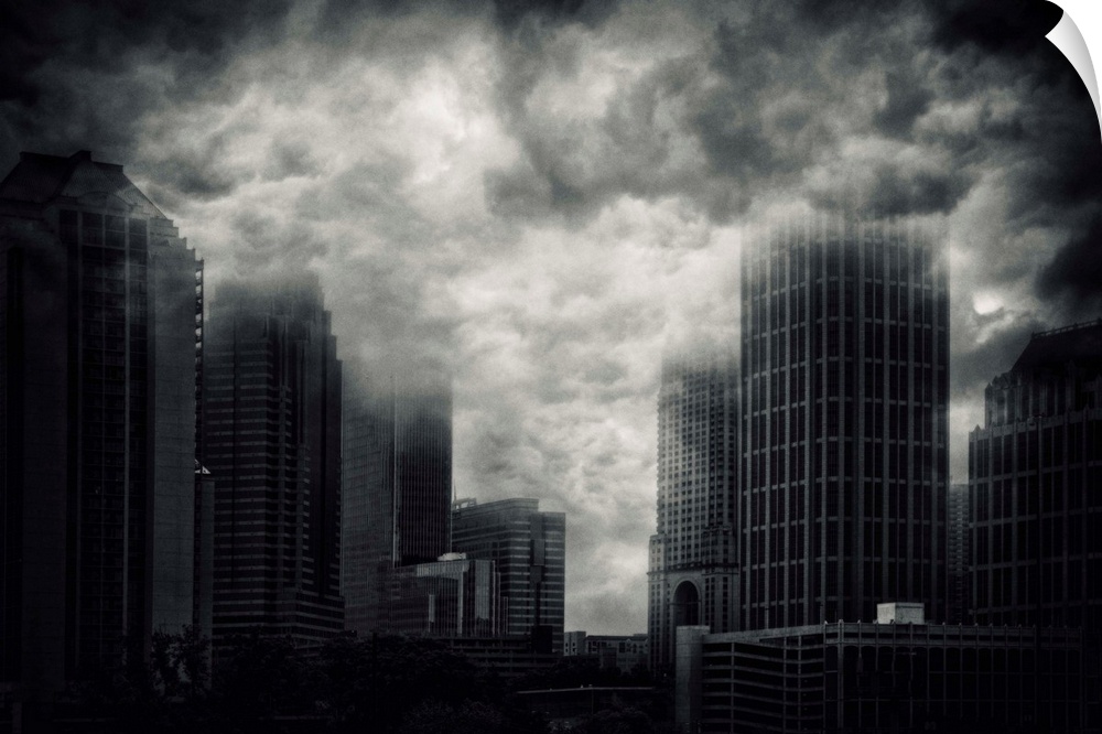 Conceptual image of storm clouds covering the tops of skyscrapers in Atlanta, Georgia.