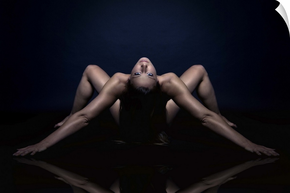 Nude portrait of a woman bending over backwards.