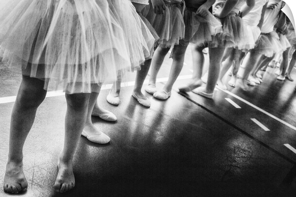 Black and white image of a group of young girls lined up for ballet class.