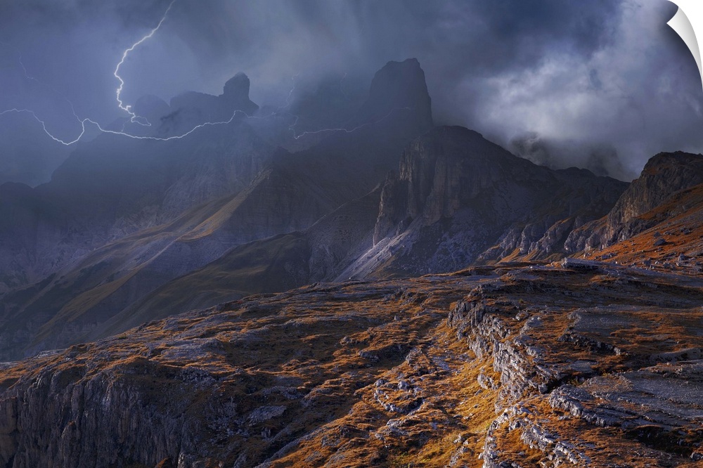 Fog shrouded mountainous landscape surrounded by striking lightning.