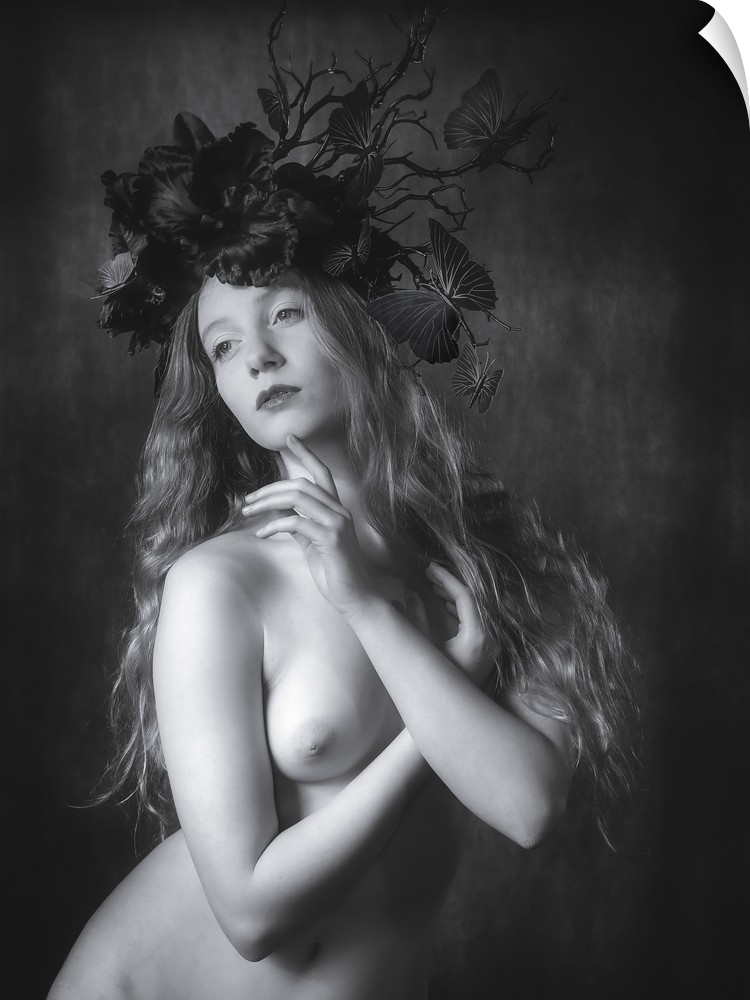 Black and white fine art portrait of a nude woman wearing a floral and butterfly headpiece.