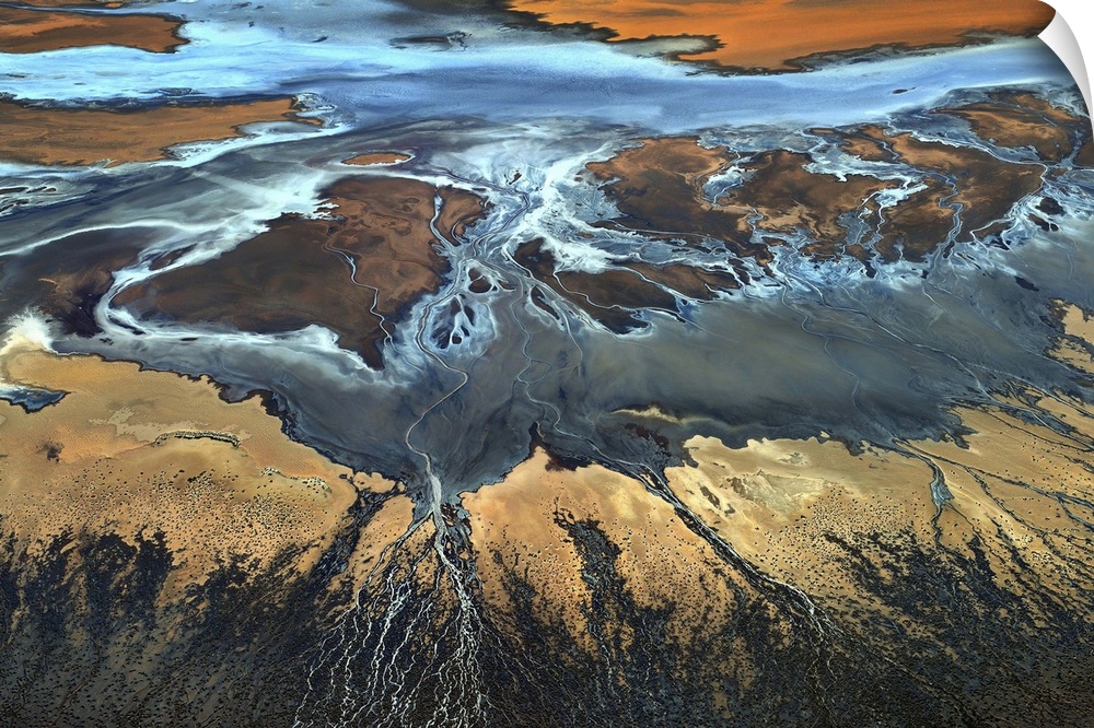 Aerial view of a desert landscape with veins of water streaming off of a main water source.