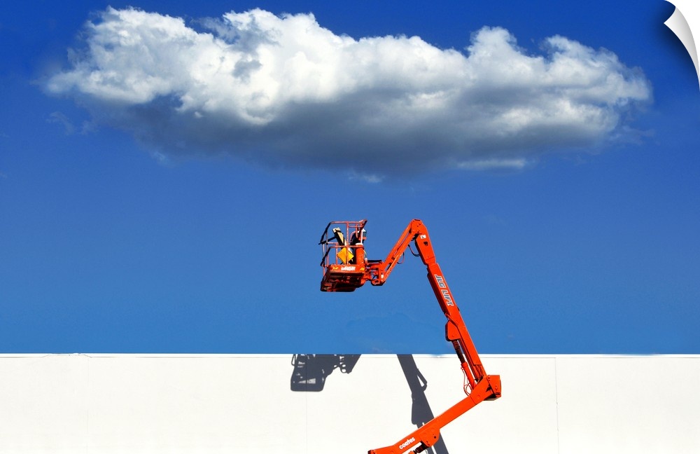 A boom lift raised near a white wall, with a cloud overhead, appearing out of reach.