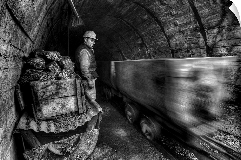 coal miners watching a mining cart whiz by in a cave.