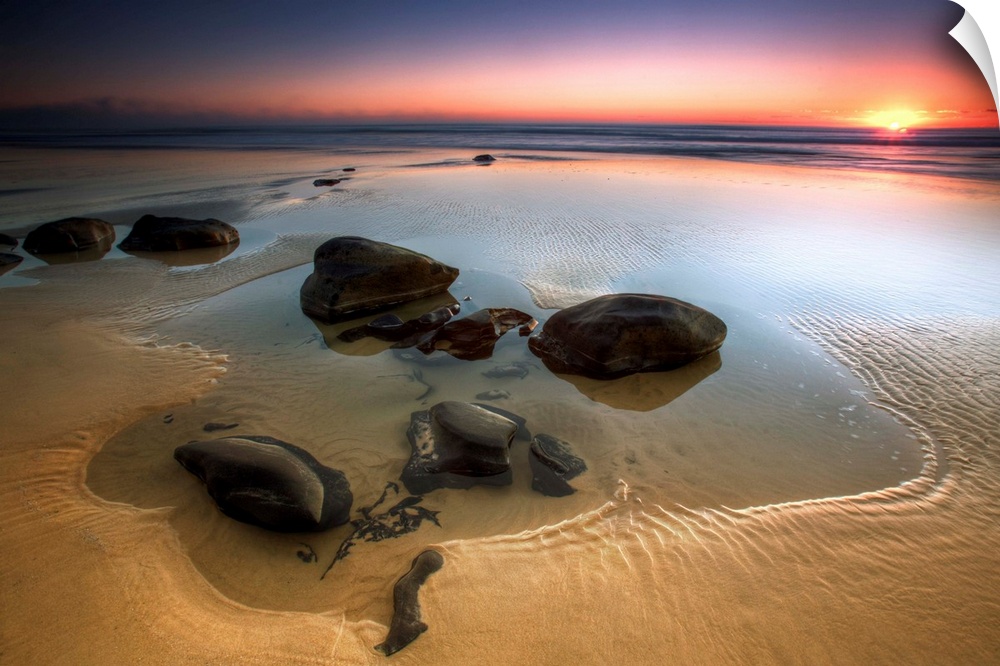 Smooth rocks in low tide on Rainbow Beach, Queensland, Australia.