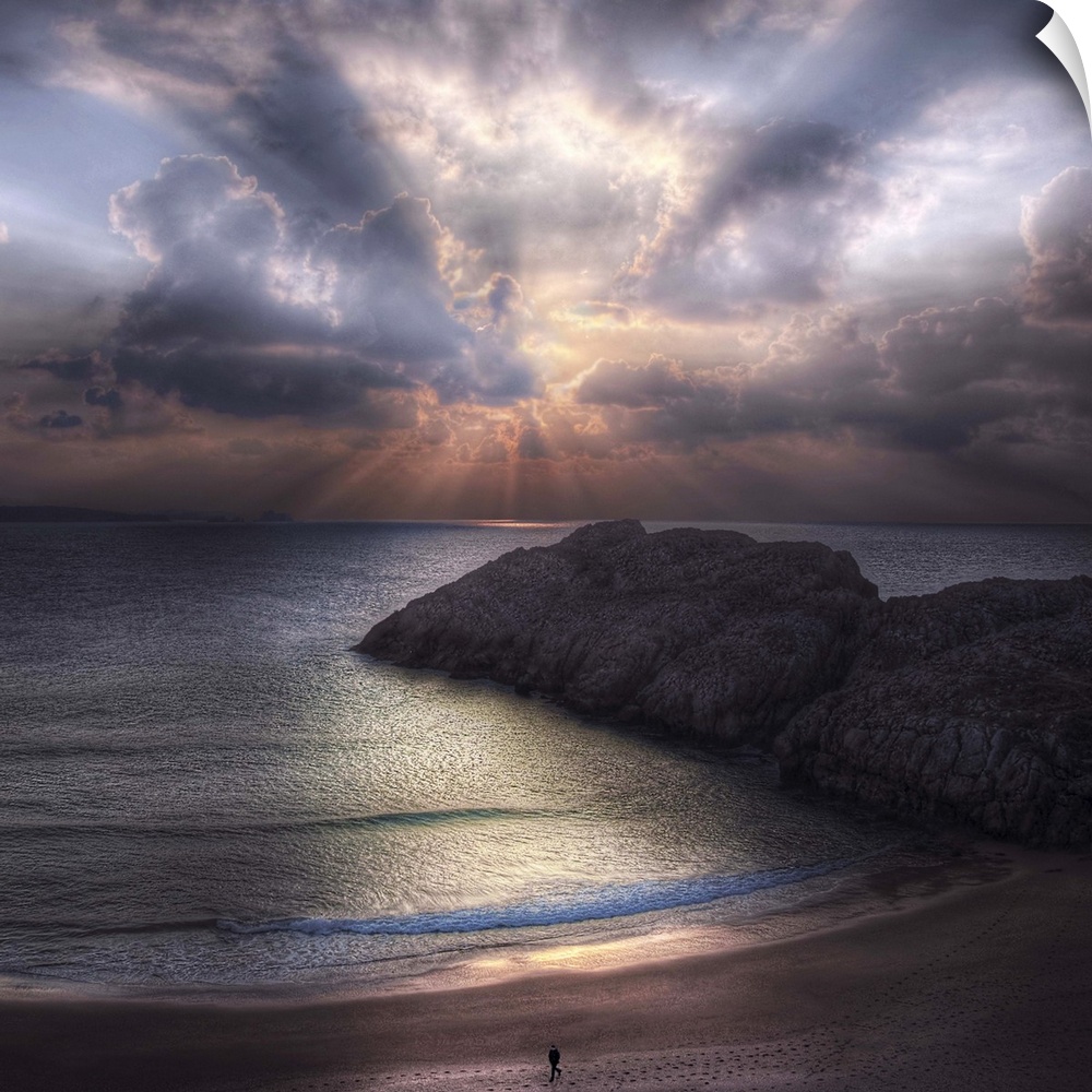 Seascape with a figure walking along the  beach and rock formations in the ocean, during sunset with a cloudy sky.
