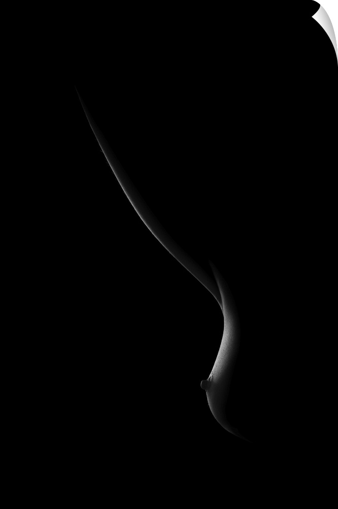 Black and white image of light on a woman's breast creating soft curving lines.