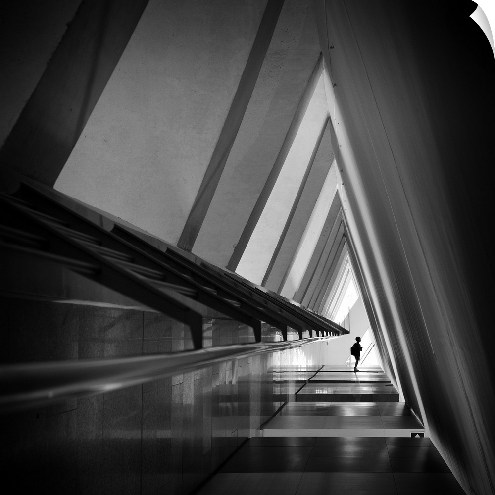 A triangular-shaped hallway in shadows with sharp corners creates an abstract image.