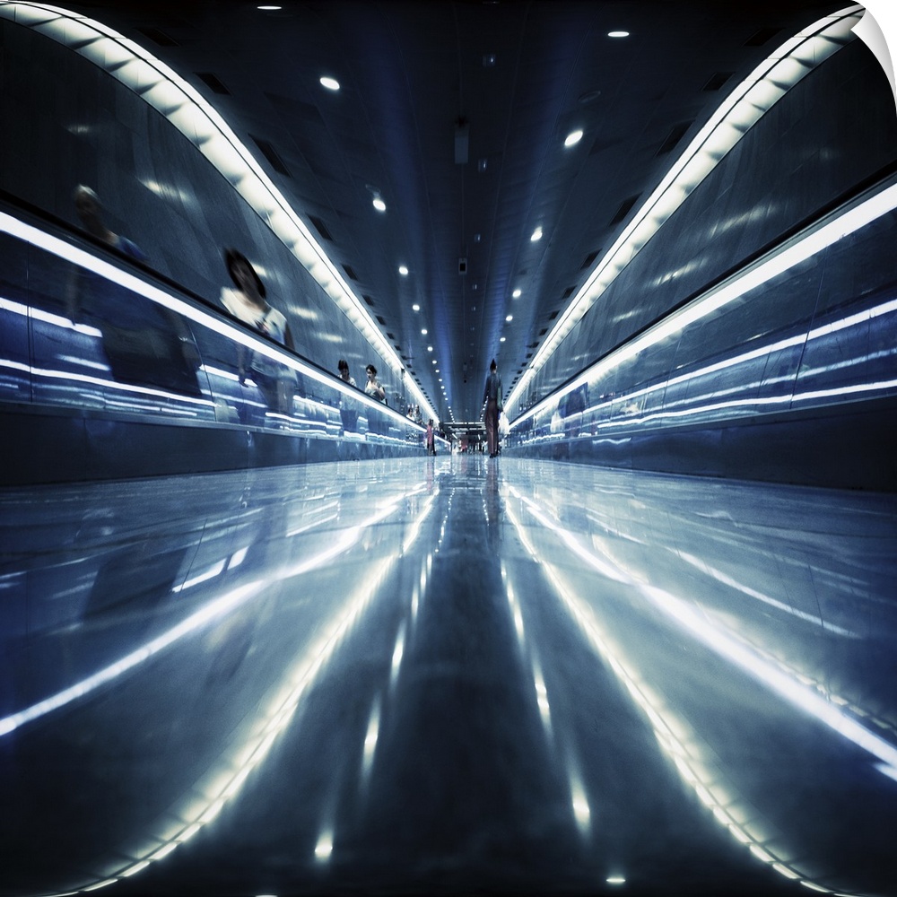 Reflective metal walkway with fluorescent lights, creating an abstract image. Barcelona Metropolitan Transport.