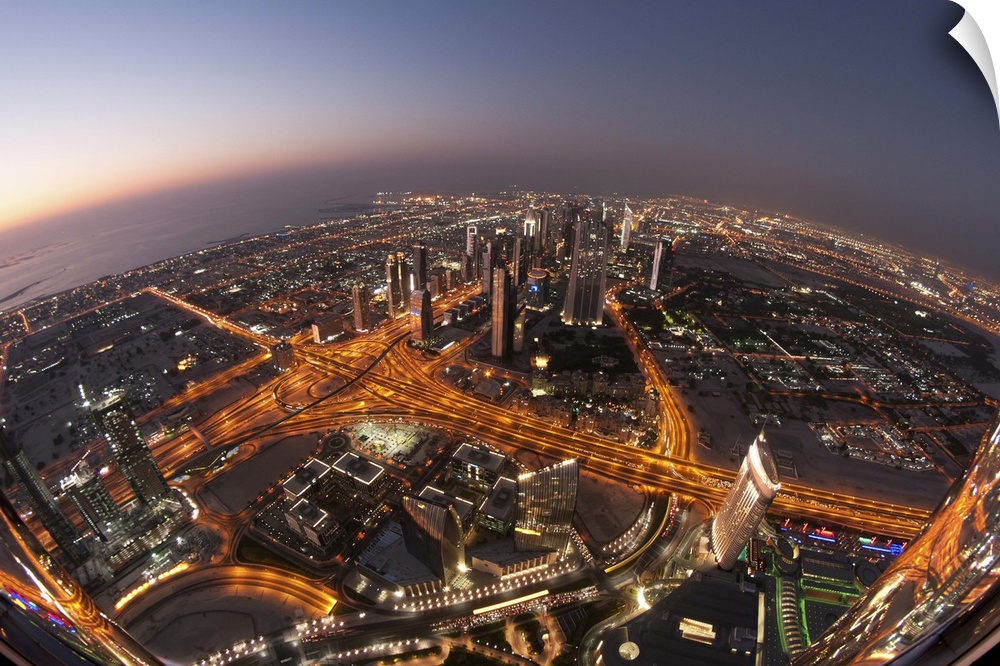 The busy city streets and skyscrapers of Dubai in the evening.