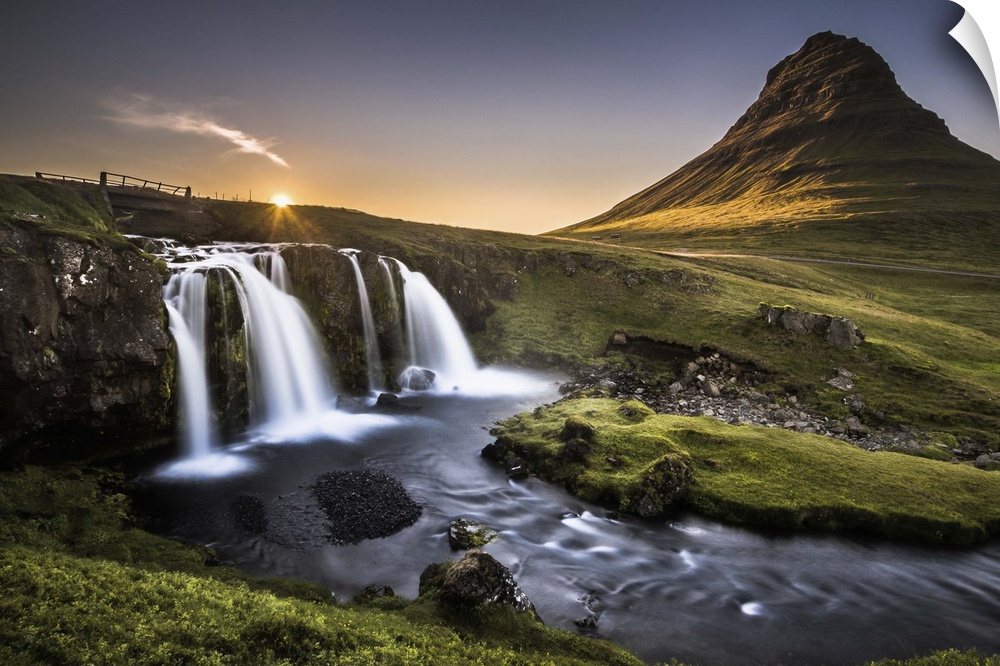 Waterfall and river near Kirkjufell mountain, Iceland, at sunset.