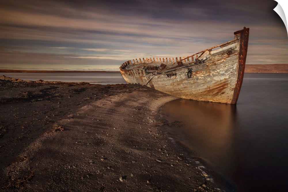 Decaying hull of an abandoned boat on the beach in Iceland.