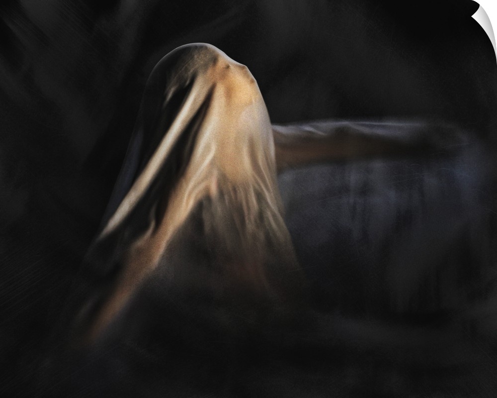 A woman dances with her face and body covered with a thin veil.