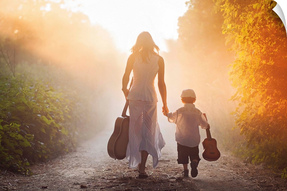A woman and a young boy, each holding a guitar, walk down a path into golden sunlight.