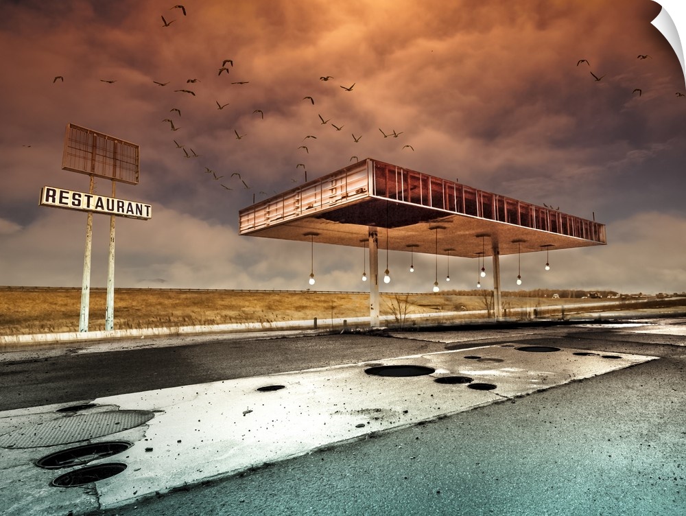 An abandoned gas station pavilion under a dramatic an intense cloudy sky.
