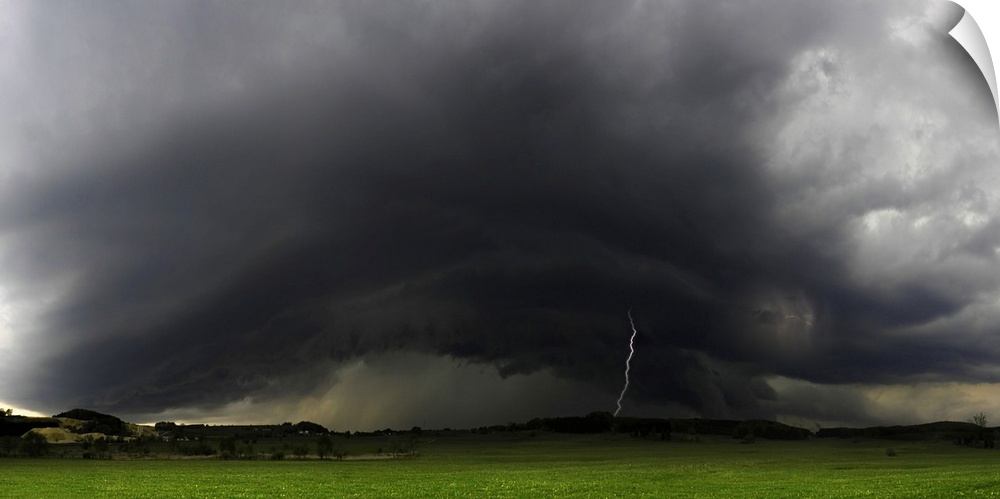 "Rolling Thunderstorms," a bolt of lightning strikes the ground from dark stormclouds over a green field.