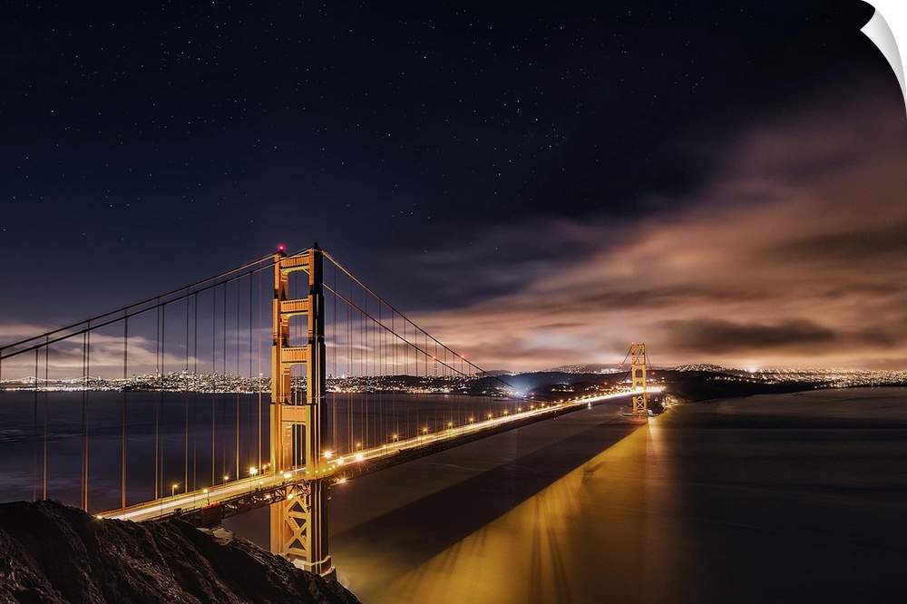 Photograph of the Golden Gate Bridge lit up at night.