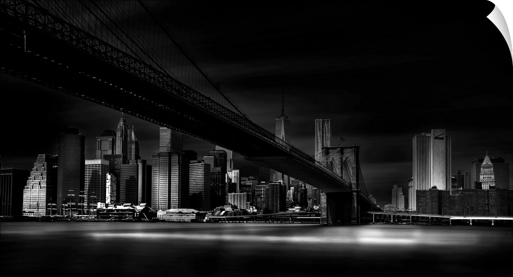 A dramatic black and white photograph of the New York city skyline with the Brooklyn bridge in the center.